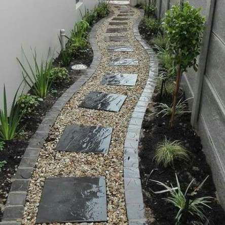 stone pathway with landscaping plants on either side of walkway